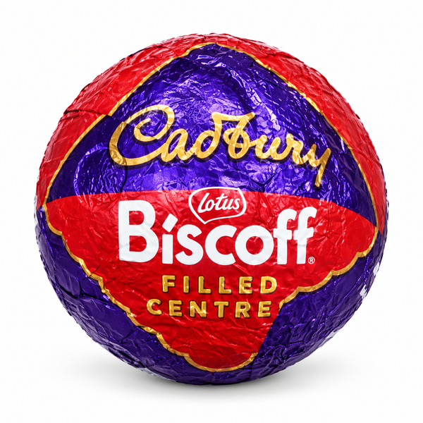 A round Cadbury Biscoff Filled Centre chocolate wrapped in metallic foil, featuring a red and purple design with gold and white lettering, isolated on a white background.