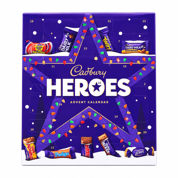 Cadbury Heroes Advent Calendar box standing upright on a tiled floor with a blurred store background. The purple box features a large star design, small numbered compartments, and illustrations of assorted chocolates and candy bars.