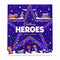 Cadbury Heroes Advent Calendar box standing upright on a tiled floor with a blurred store background. The purple box features a large star design, small numbered compartments, and illustrations of assorted chocolates and candy bars.