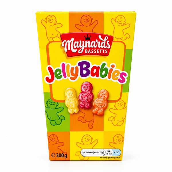 A box of Maynard's Bassetts Jelly Babies candy standing upright on a white surface with a blurred indoor background.
