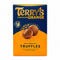 A box of Terry's Chocolate Orange Truffles standing on a wooden surface with a blurred store background.