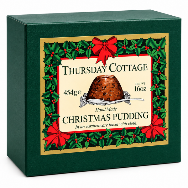 A dark green square gift box for Thursday Cottage Christmas Pudding, featuring a festive front label with holly, red bows, and an illustration of the pudding.