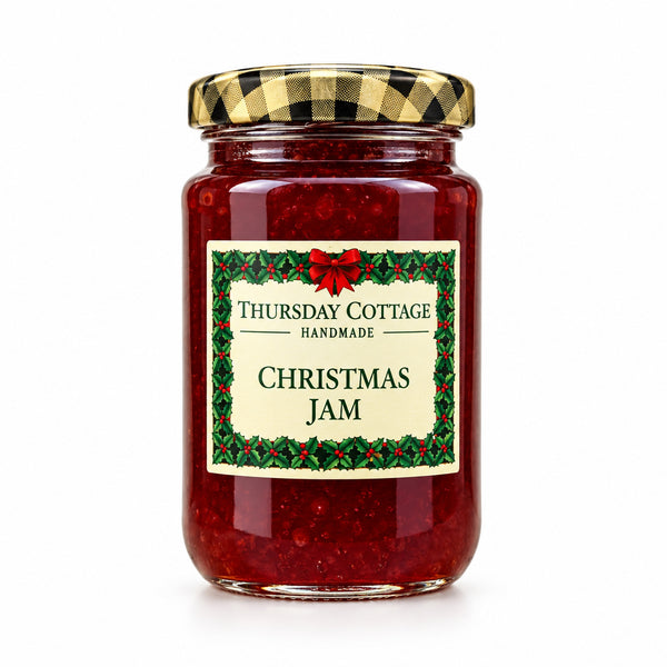 A glass jar of Thursday Cottage Handmade Christmas Jam with a gold and black checkered lid, set against a plain white background.